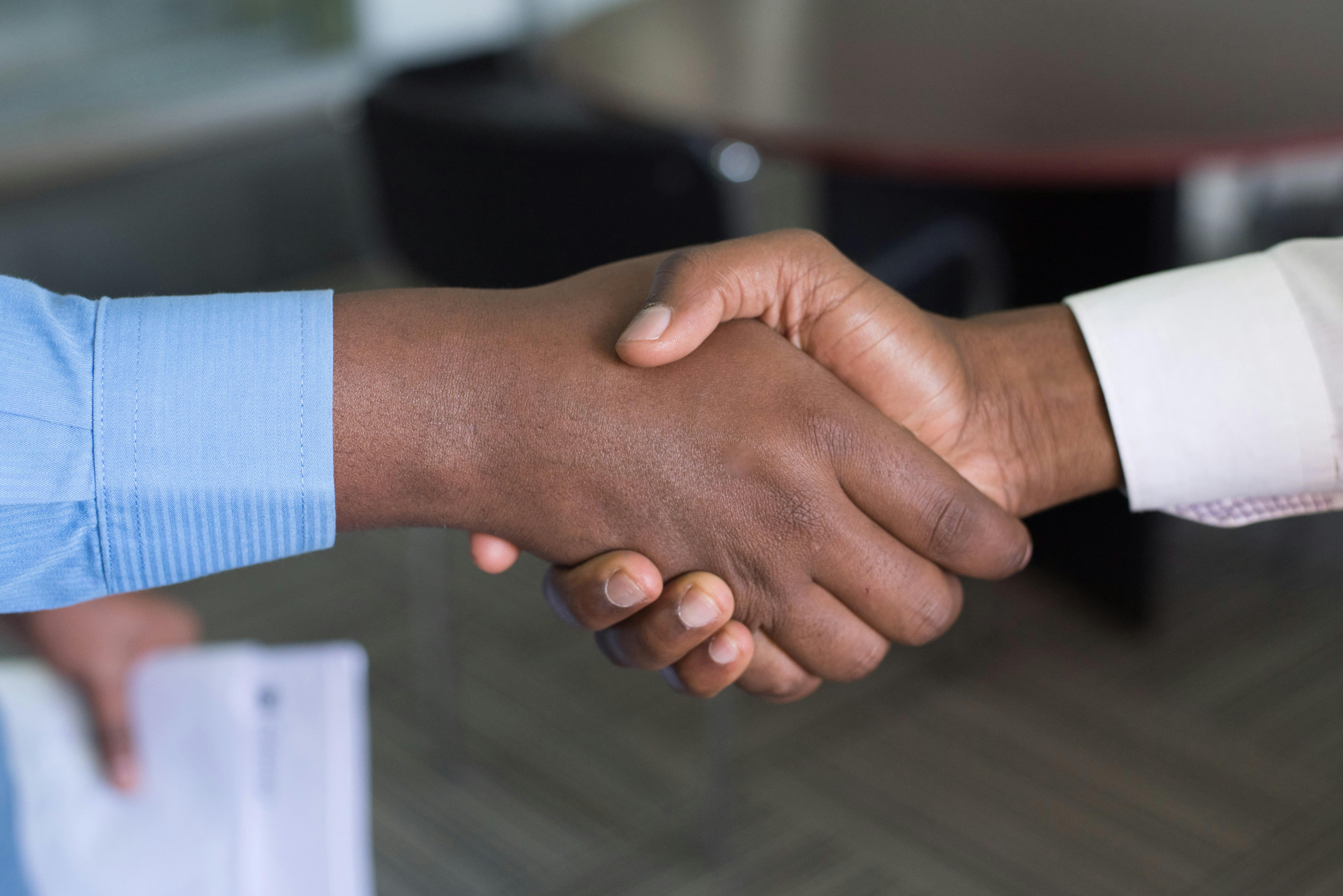 Professional business handshake representing solar partnership opportunities with Kasot Power in Nigeria